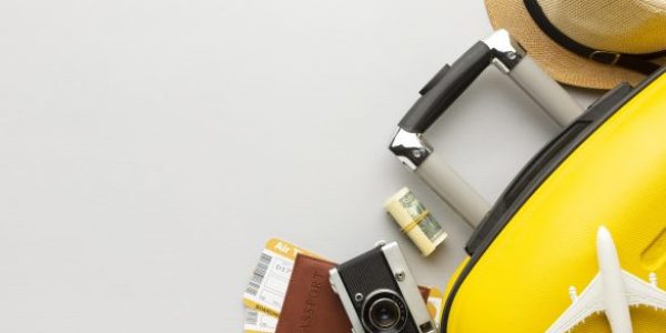 flat-lay-yellow-luggage-with-copy-space-1-585x390